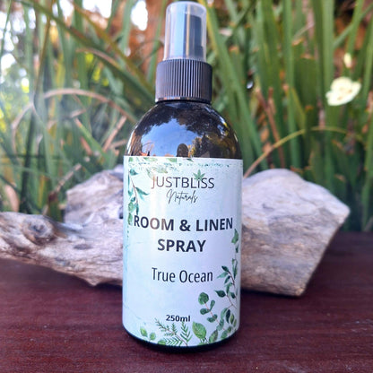 ROOM & LINEN SPRAY bottle labeled "True Ocean" with refreshing scent, ideal for relaxing and uplifting atmosphere.