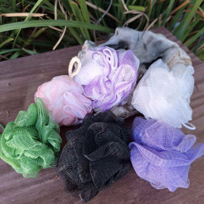 Colorful bath shower assorted scrunchies arranged on a wooden surface.