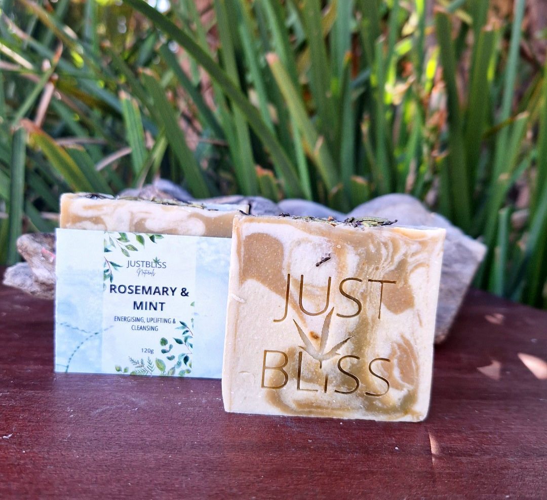 Rosemary and mint soap bar with natural ingredients on display in garden setting.