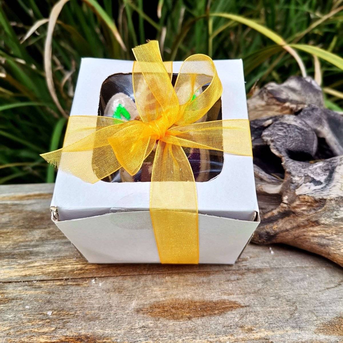 Unicorn bath bomb gift box with yellow ribbon, ideal for luxury bath time.