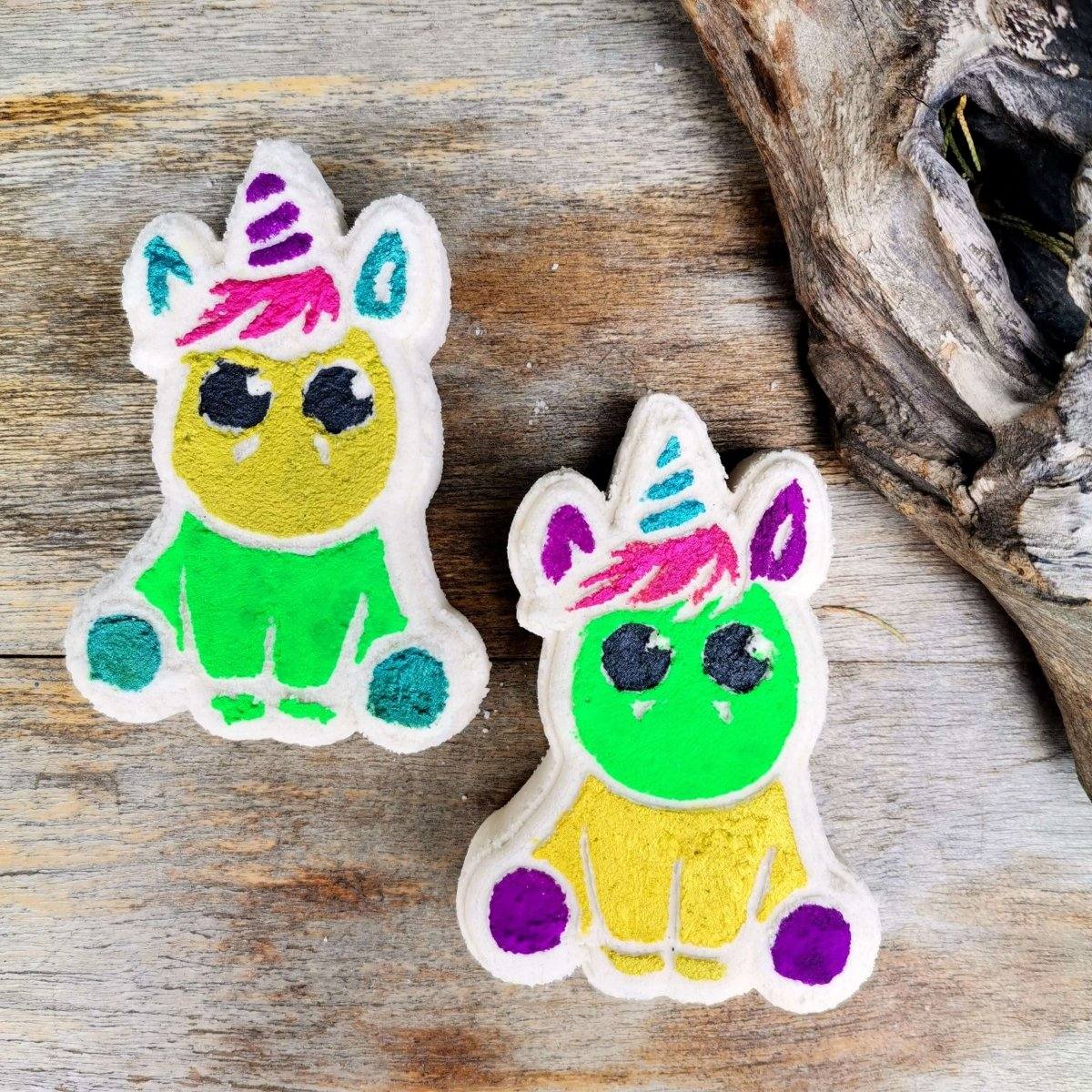 Unicorn-shaped bath bombs on wooden surface, colorful design, luxurious bath product.