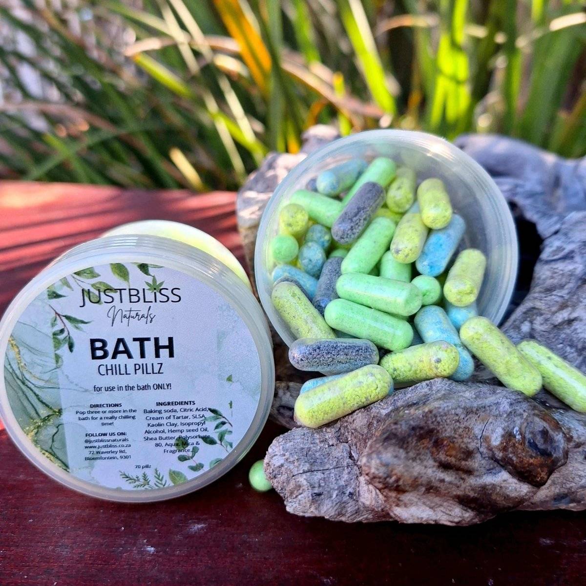 Container of Bath Chill Pillz mini bath bomb capsules on a natural background.