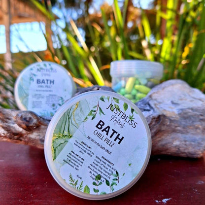 BATH CHILL PILLZ mini bath bombs in container, nature-inspired setting.