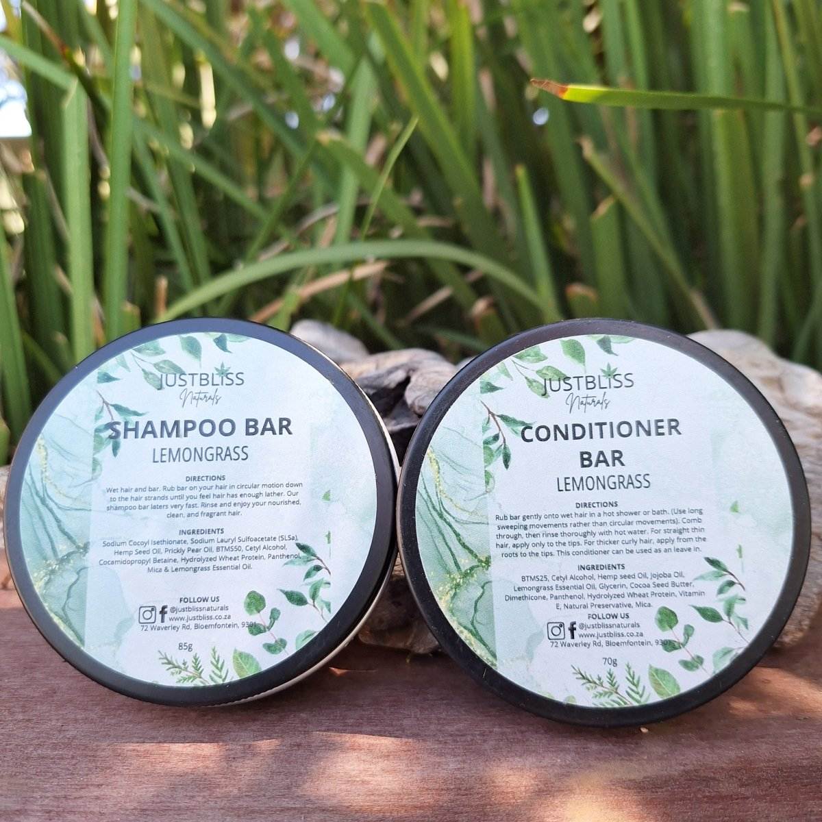 SHAMPOO and CONDITIONER BAR: Lemongrass combo in tins on a wooden surface with greenery in the background.