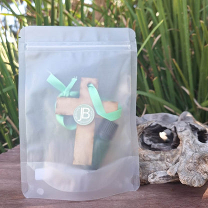 Woody Hanging Diffuser with mystery scent package outdoors with green ribbon.