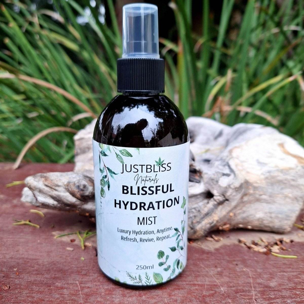 Blissful Hydration Facial Mist (Luxury Hydration) bottle with nature background.