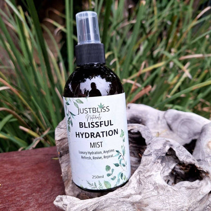 Blissful Hydration Facial Mist bottle among natural greenery, offering luxury skin hydration.