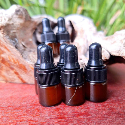 Prickly Pear Seed Oil tester bottles arranged on a wooden surface with natural background.