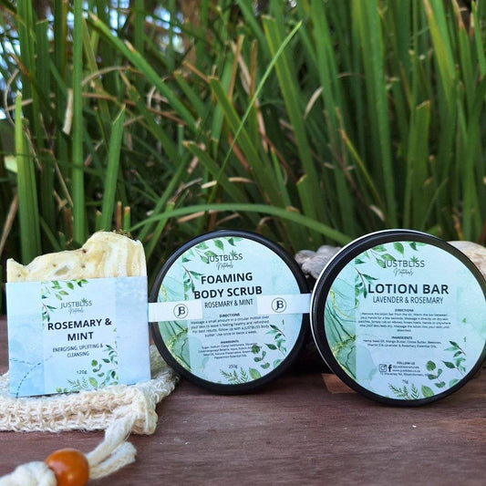 Rosemary & Mint Gift Box 2 gift set with soap, body scrub, and lotion bar displayed outdoors.