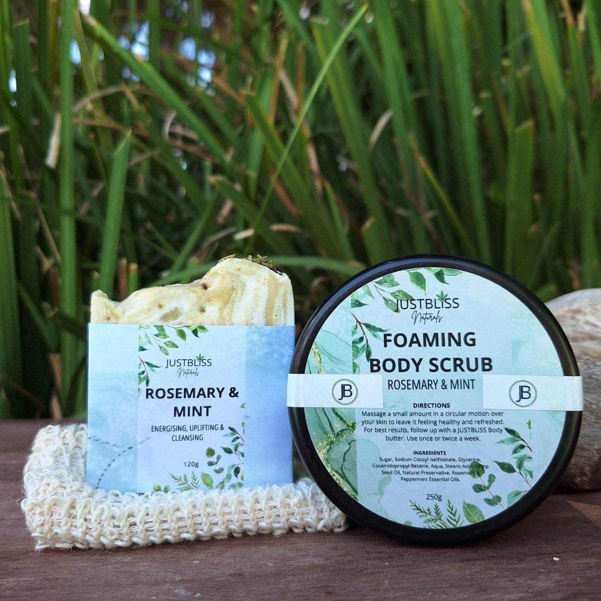 Rosemary & Mint gift box with body scrub and soap bar on natural loofah background.