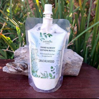 HAND & BODY: Lotion Refill (200g) with natural oils on wooden surface and greenery backdrop.