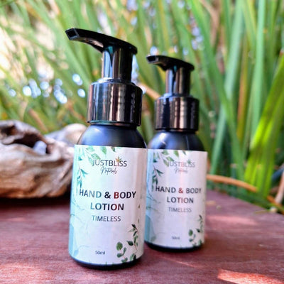 Travel size hand and body lotion bottles from JUSTBLiSS on natural background.