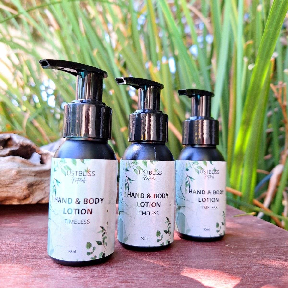 Travel size hand and body lotion, 50ml bottles on a natural background, featuring nourishing plant oils for silky smooth skin.