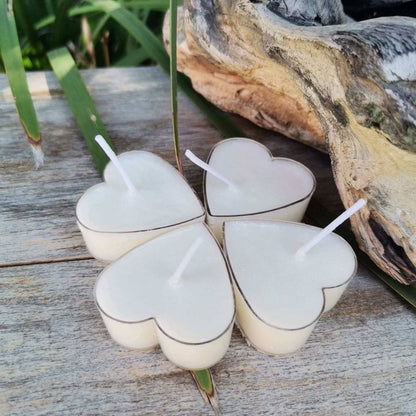 Heart-shaped soy tealight candles with hemp wicks outdoors.