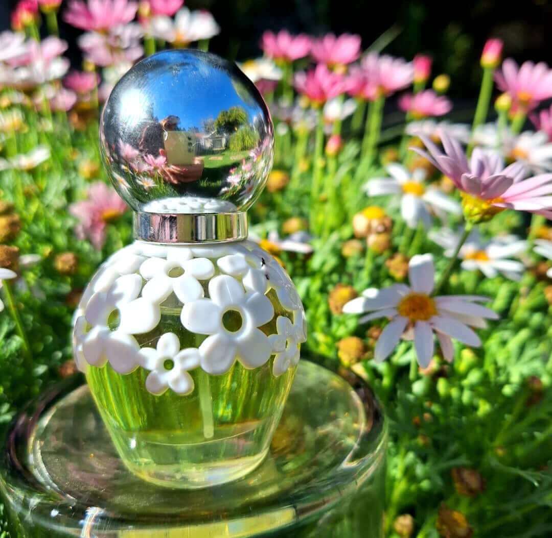 30ml Isadora floral perfume bottle with floral design in a garden setting.