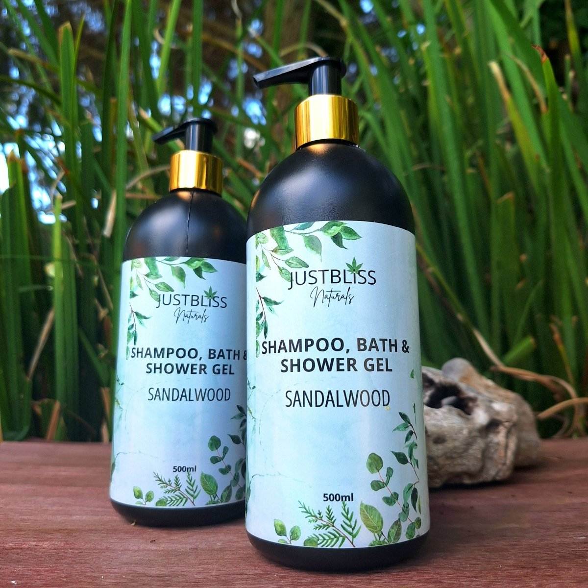 3-in-1 Luxurious JUSTBLiSS sandalwood shampoo, bath & shower gel bottle outdoors.