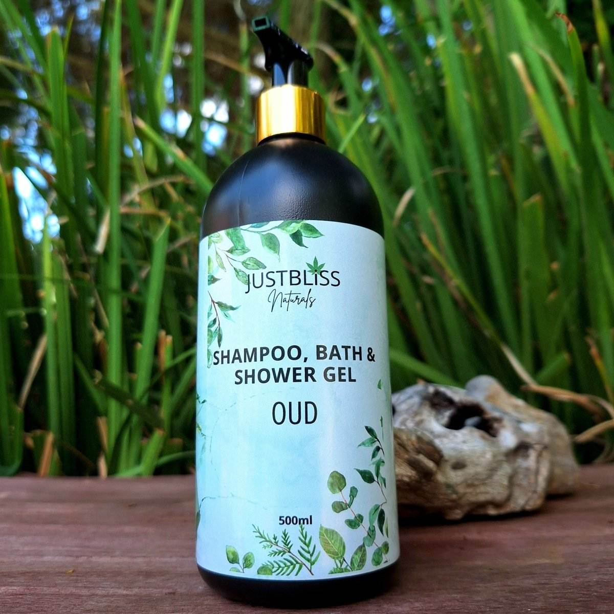 3-in1 SHAMPOO, BATH & SHOWER GEL - 500ml bottle outdoors with plant background.