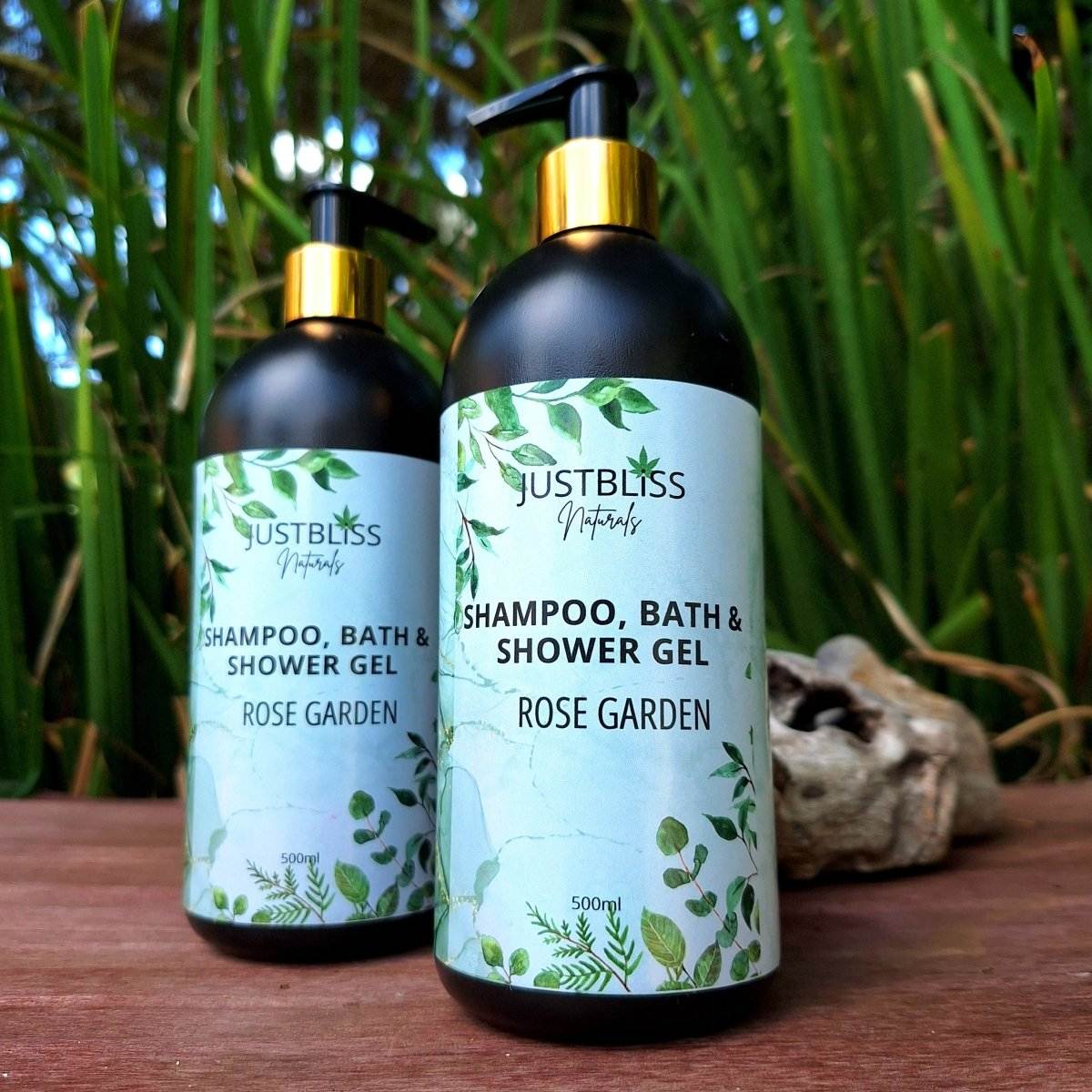 3-in-1 SHAMPOO, BATH & SHOWER GEL bottles with green botanical design on wooden surface.