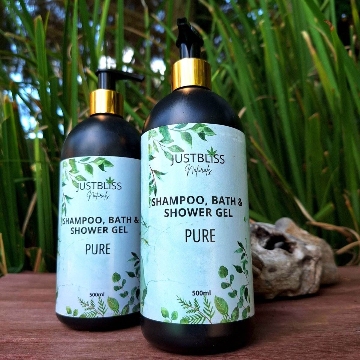 3-in-1 SHAMPOO, BATH & SHOWER GEL 500ml bottles with natural formula, background of greenery.