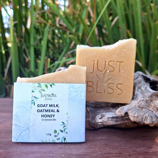 Soap bar with goat milk, oatmeal, and honey for sensitive skin, featuring natural ingredients like shea butter and avocado oil, on display with packaging.