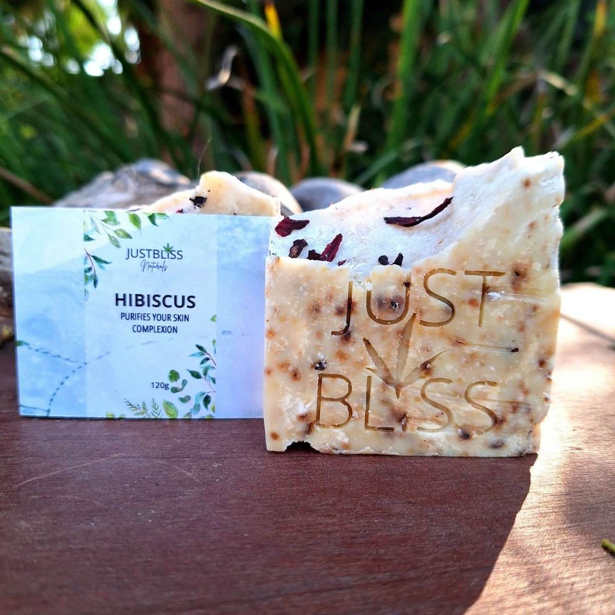 Hibiscus infused handmade soap bar with nourishing oils on a natural background.